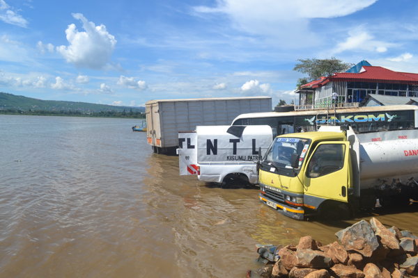  Trucks and a bus are washed right in Lake Victoria at Lwang'ni beach in Kisumu, Kenya. The business is illegal but it goes on with the knowledge of environmental authorities. Photo credit: Isaiah Esipisu.