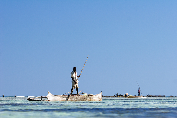 A fisherman punts out to a reef flat to fish for octopus. Photo copyright: Garth Cripps / Blue Ventures 2015.