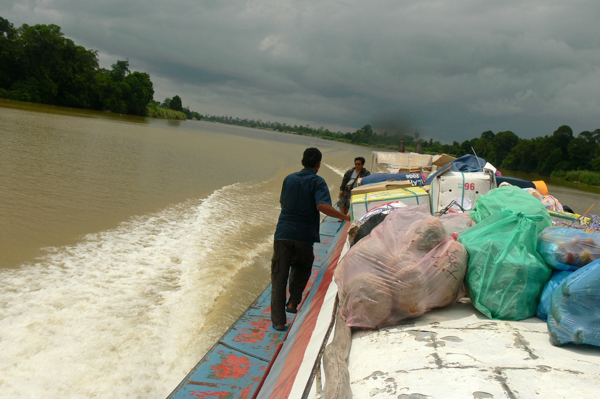 A boat carries cargo up the Baram River, in Sarawak, Malaysia, in August 2011. Photo credit: MyBukit.