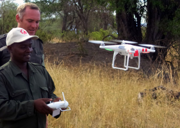 RESOLVE partner Marc Goss instructs a TAWIRI (Tanzania Wildlife Research Institute) ranger on how to land a drone. Photo Credit: Jonathan Konuche.