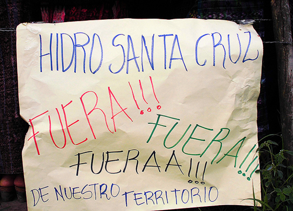 A sign at a protest against hydroelectric dams in Santa Cruz Barillas on March 15, 2014. The sign refers to the company responsible for a contentious dam that has been linked to murders and detentions of local activists, saying "Hidro Santa Cruz Out!!! Out!!! Out!!! of our territory" Photo credit: Luis Miranda Brugos / Alba Sud Fotografia.